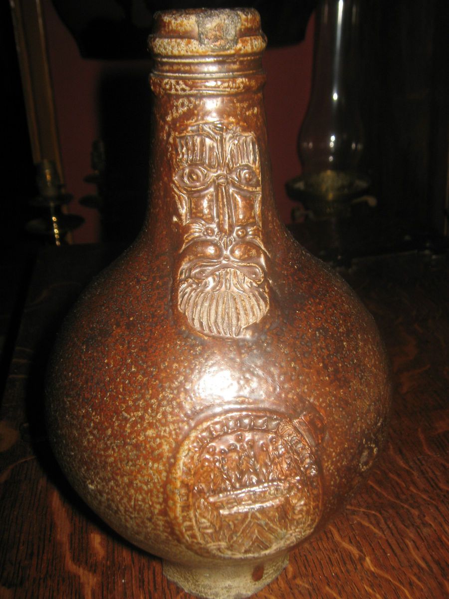   this 16th 17th century tiger glaze bellarmine jug with mask and script