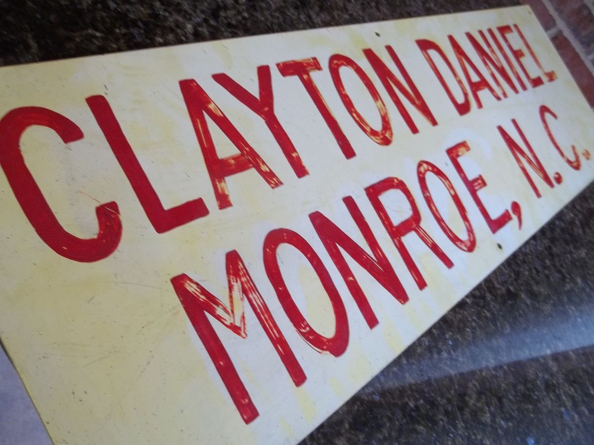   Vintage Painted Metal Retail Sign Clayton Daniel Monroe N C 32 x10
